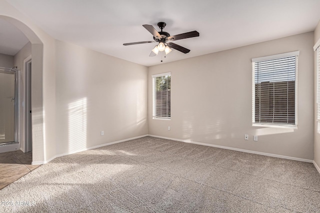 carpeted spare room with ceiling fan