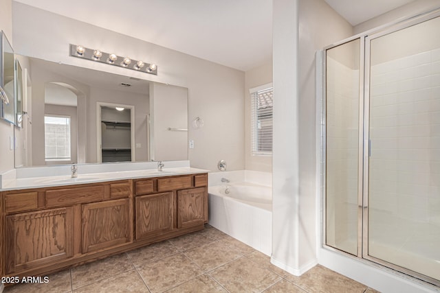 bathroom featuring tile patterned floors, plenty of natural light, vanity, and independent shower and bath