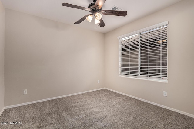 carpeted spare room with ceiling fan