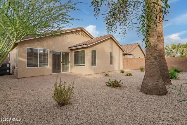 rear view of property featuring cooling unit and a patio area