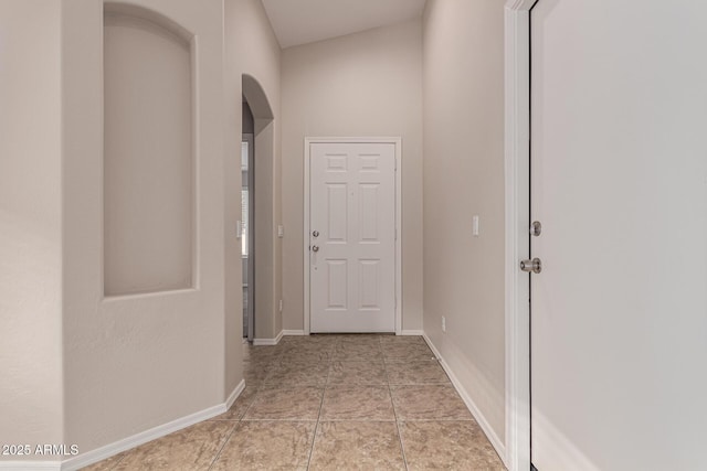 hall with light tile patterned floors