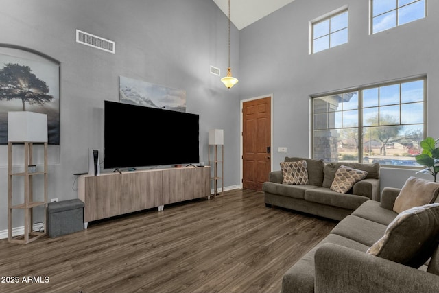 living room with a healthy amount of sunlight and dark hardwood / wood-style flooring