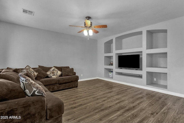 unfurnished living room featuring hardwood / wood-style floors, built in features, and ceiling fan