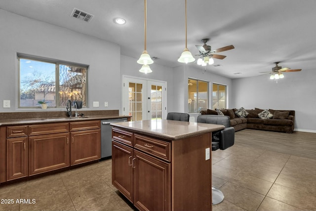 kitchen with french doors, sink, plenty of natural light, dishwasher, and pendant lighting