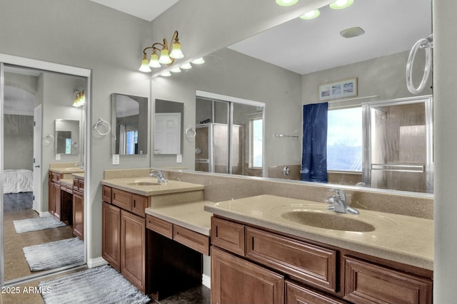 bathroom with vanity and a shower with door