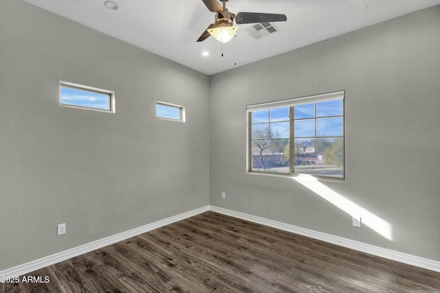 spare room with plenty of natural light, dark hardwood / wood-style floors, and ceiling fan