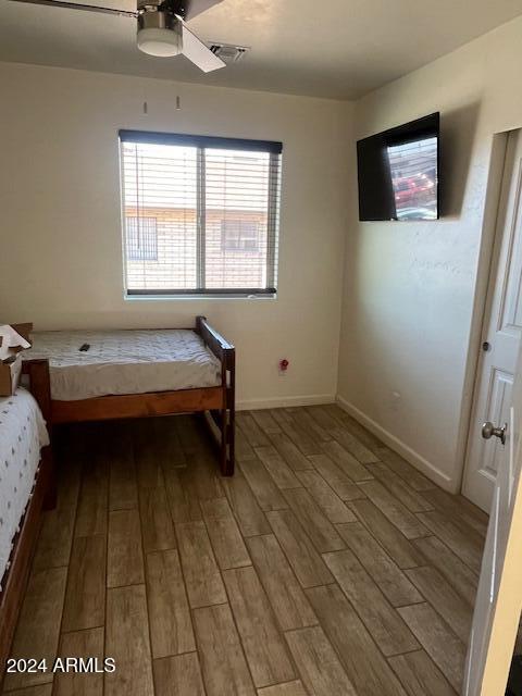 unfurnished bedroom with hardwood / wood-style floors and ceiling fan