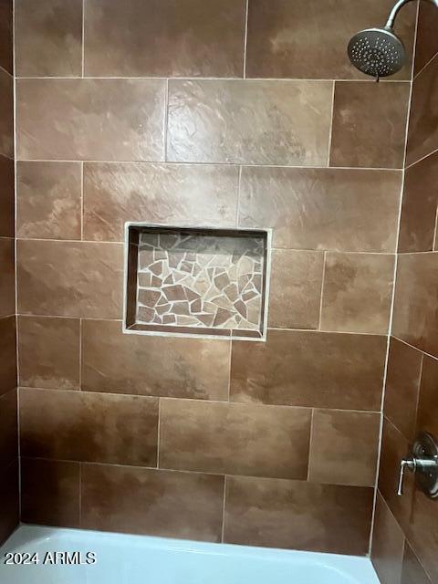 interior details with a tile shower