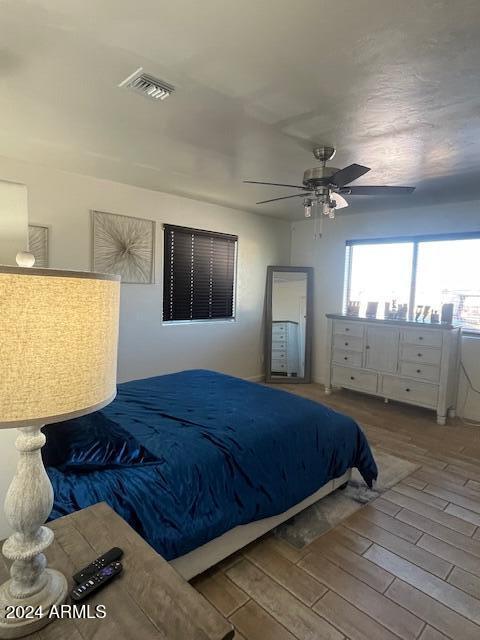 bedroom featuring hardwood / wood-style flooring and ceiling fan