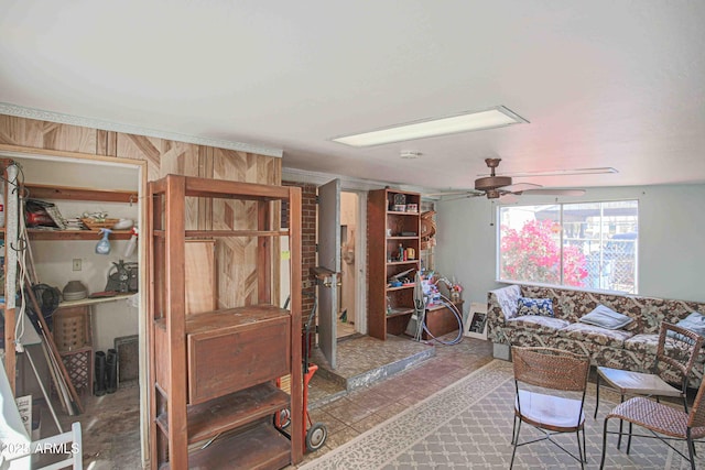 living room featuring wooden walls and ceiling fan