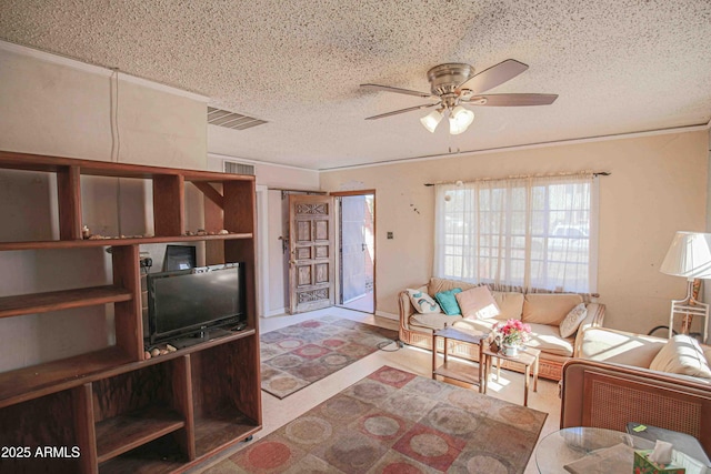 living room featuring ceiling fan and a textured ceiling