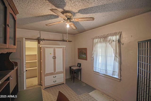 interior space featuring a textured ceiling and ceiling fan