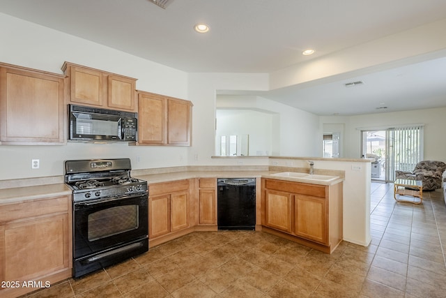 kitchen featuring light tile patterned flooring, sink, kitchen peninsula, and black appliances