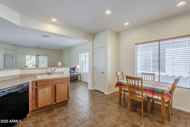 kitchen featuring sink, light tile patterned floors, and dishwasher