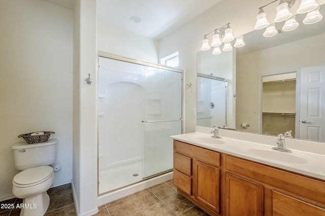 bathroom with vanity, tile patterned floors, a shower with door, and toilet