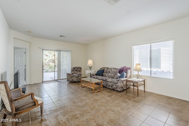 living room featuring a wealth of natural light and light tile patterned floors