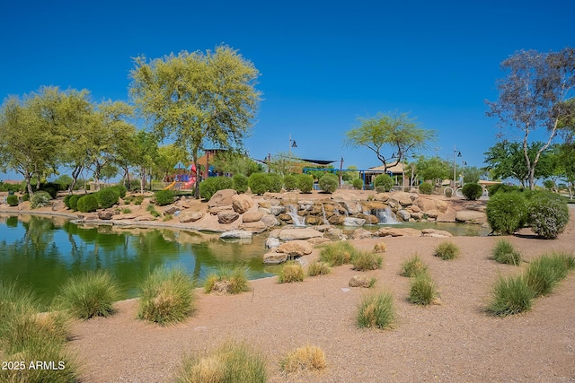 exterior space featuring a water view and a playground