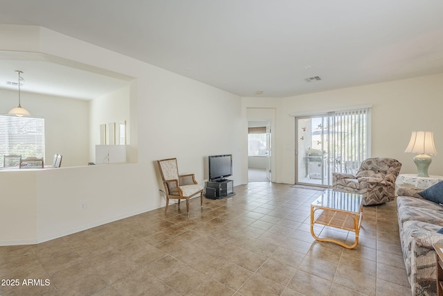 living room featuring light tile patterned floors and a wealth of natural light