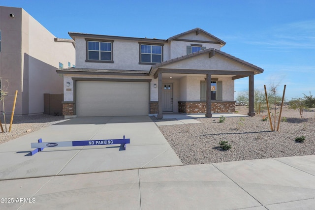 view of front facade with a porch, stucco siding, an attached garage, and concrete driveway