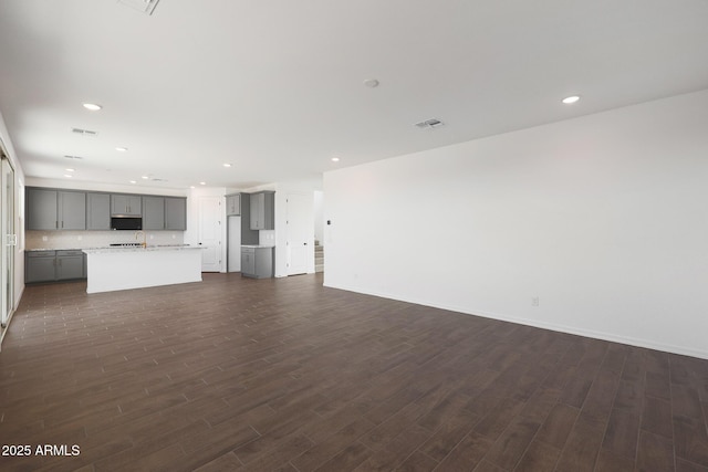 4106 W Eli Dr, San Tan Valley, AZ 85144 - unfurnished living room with visible vents, recessed lighting, baseboards, and dark wood-style flooring