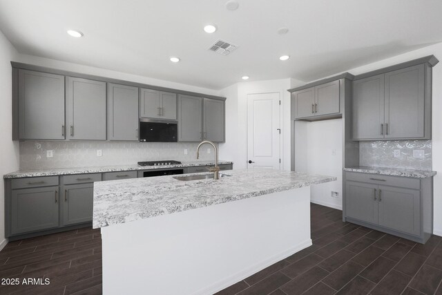 4106 W Eli Dr, San Tan Valley, AZ 85144 - kitchen with visible vents, gray cabinetry, an island with sink, a sink, and wood tiled floor
