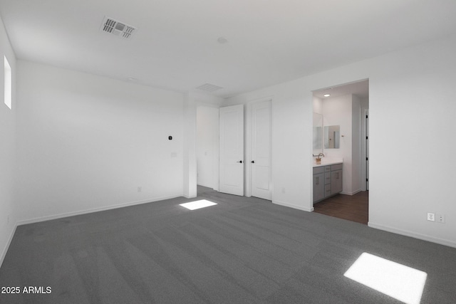 4106 W Eli Dr, San Tan Valley, AZ 85144 - unfurnished bedroom with visible vents, baseboards, connected bathroom, and dark carpet