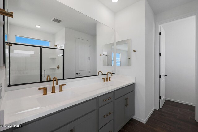 4106 W Eli Dr, San Tan Valley, AZ 85144 - full bath with double vanity, a shower stall, wood finished floors, and a sink