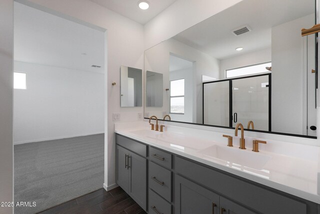 4106 W Eli Dr, San Tan Valley, AZ 85144 - full bathroom featuring double vanity, a stall shower, visible vents, and a sink