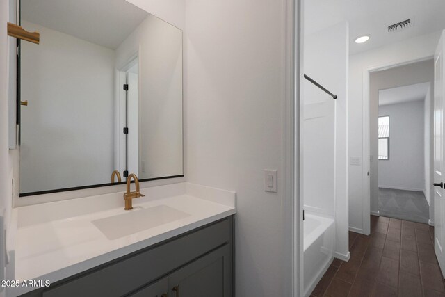 4106 W Eli Dr, San Tan Valley, AZ 85144 - full bath with visible vents, baseboards, bathtub / shower combination, wood finished floors, and vanity