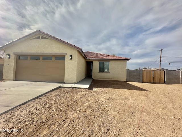11216 W Apache St, Avondale, AZ 85323 - ranch-style house featuring stucco siding, a tile roof, a garage, and fence