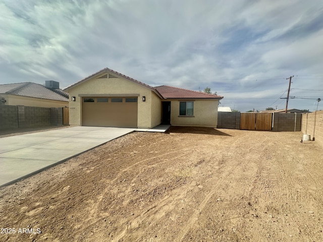 11216 W Apache St, Avondale, AZ 85323 - ranch-style home with fence, concrete driveway, a garage, stucco siding, and a tiled roof
