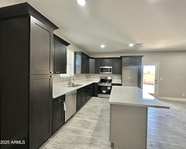 kitchen featuring stainless steel appliances, visible vents, plenty of natural light, and a sink