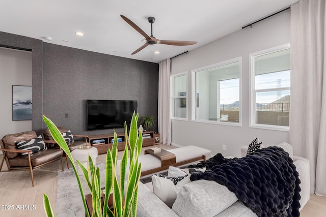 living room with hardwood / wood-style flooring and ceiling fan