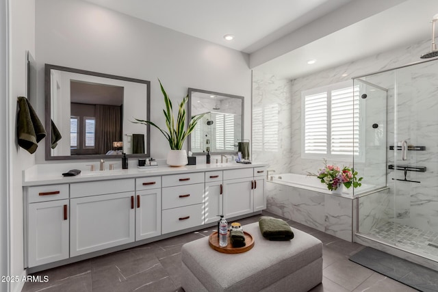 bathroom featuring vanity and independent shower and bath