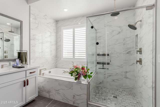 bathroom with vanity and separate shower and tub