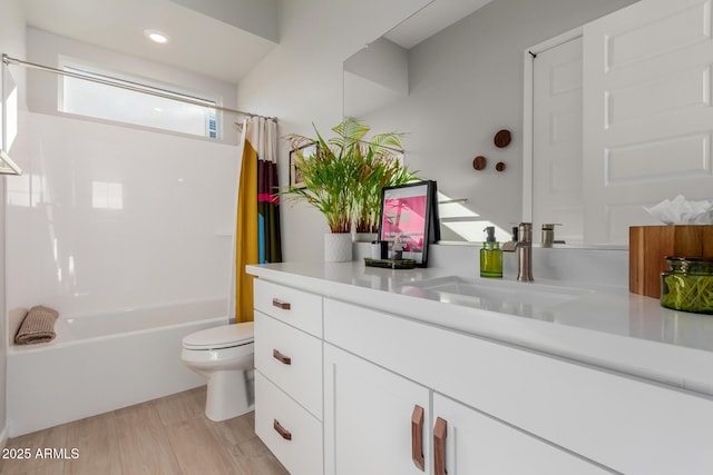 full bathroom featuring vanity, wood-type flooring, shower / bath combination with curtain, and toilet