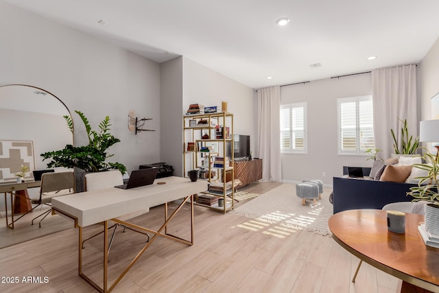 home office with light hardwood / wood-style floors