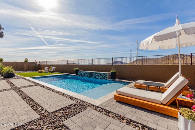 view of pool with a patio and pool water feature