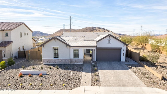 view of front of property with a garage and a mountain view