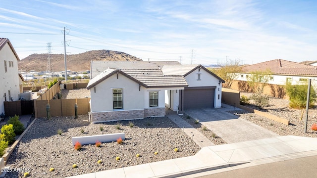 view of front of home with a garage and a mountain view