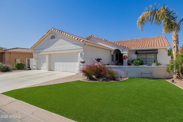 mediterranean / spanish-style home featuring a garage and a front lawn