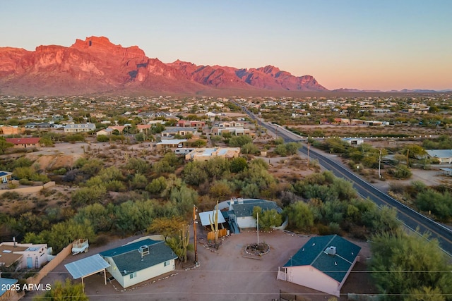 aerial view at dusk featuring a mountain view