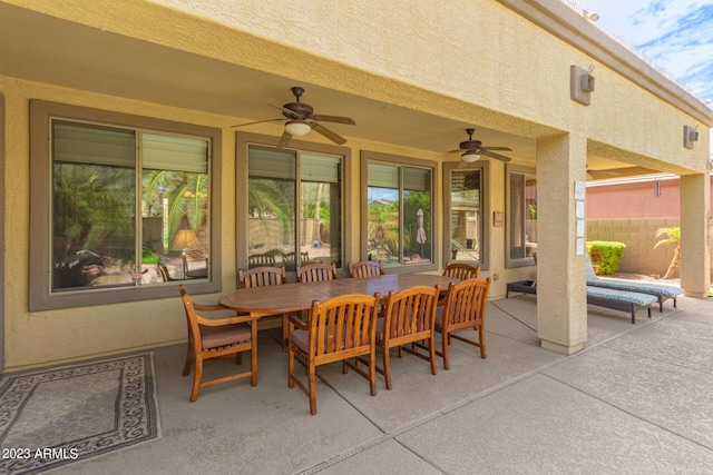 view of patio / terrace with ceiling fan, outdoor dining area, and fence