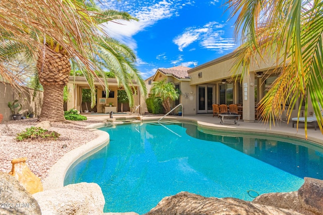 view of pool featuring a patio area, ceiling fan, fence, and a fenced in pool