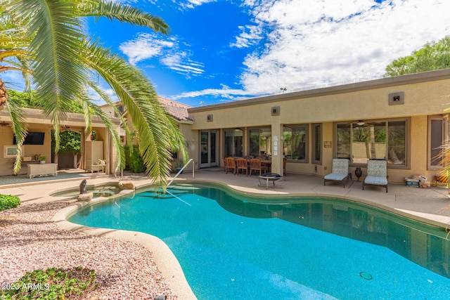 view of pool featuring a patio area and a pool with connected hot tub