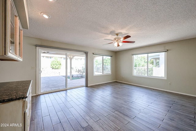 interior space with hardwood / wood-style floors, ceiling fan, and a textured ceiling