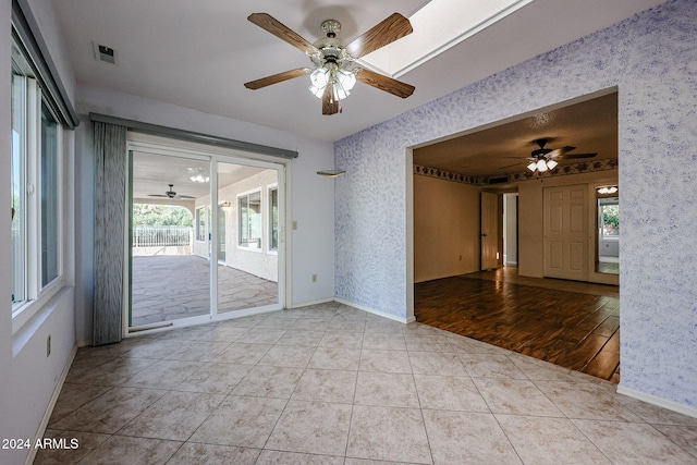 spare room featuring light wood-type flooring and ceiling fan