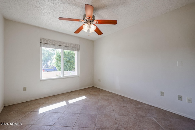 unfurnished room featuring a textured ceiling, tile patterned floors, and ceiling fan