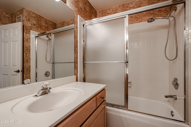 bathroom featuring vanity and bath / shower combo with glass door