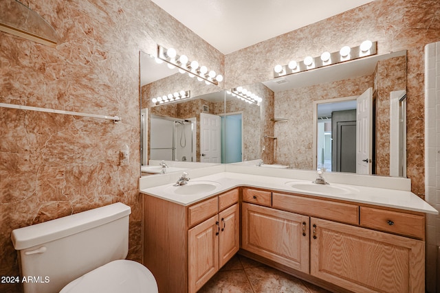 bathroom featuring toilet, vanity, tile patterned floors, and an enclosed shower